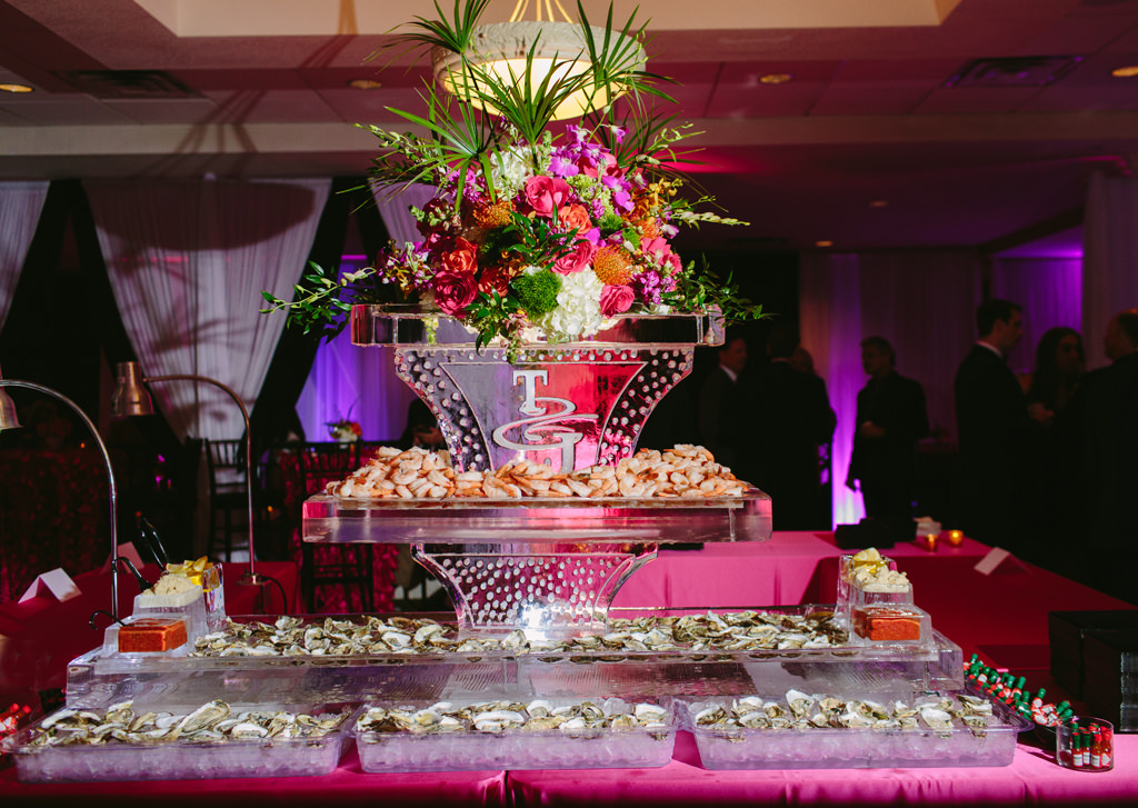 Whimsical Kate Spade Inspired Wedding Reception Decor, Seafood Cocktail Table with Ice Sculpture Engraved with Monogram and Colorful Pink, Orange, White, Green, and Purple Flower Topper | Tampa Bay Wedding Planner Parties A La Carte