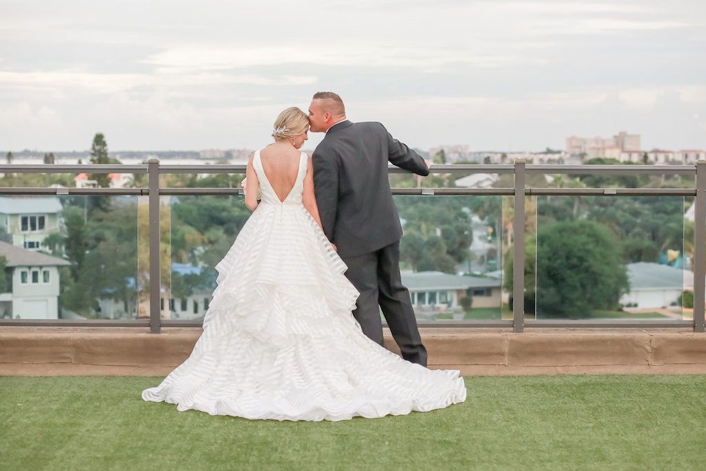 Florida Bride and Groom Hotel Rooftop Terrace Wedding Portrait | Bride in Organza Flowy Low V-Back with Horsehair Edging, Thick Straps Morilee Ballgown Wedding Dress | Tampa Bay Wedding Photographer Lifelong Photography Studios | St. Pete Beach Wedding Venue Hotel Zamora | Dress Shop Truly Forever Bridal