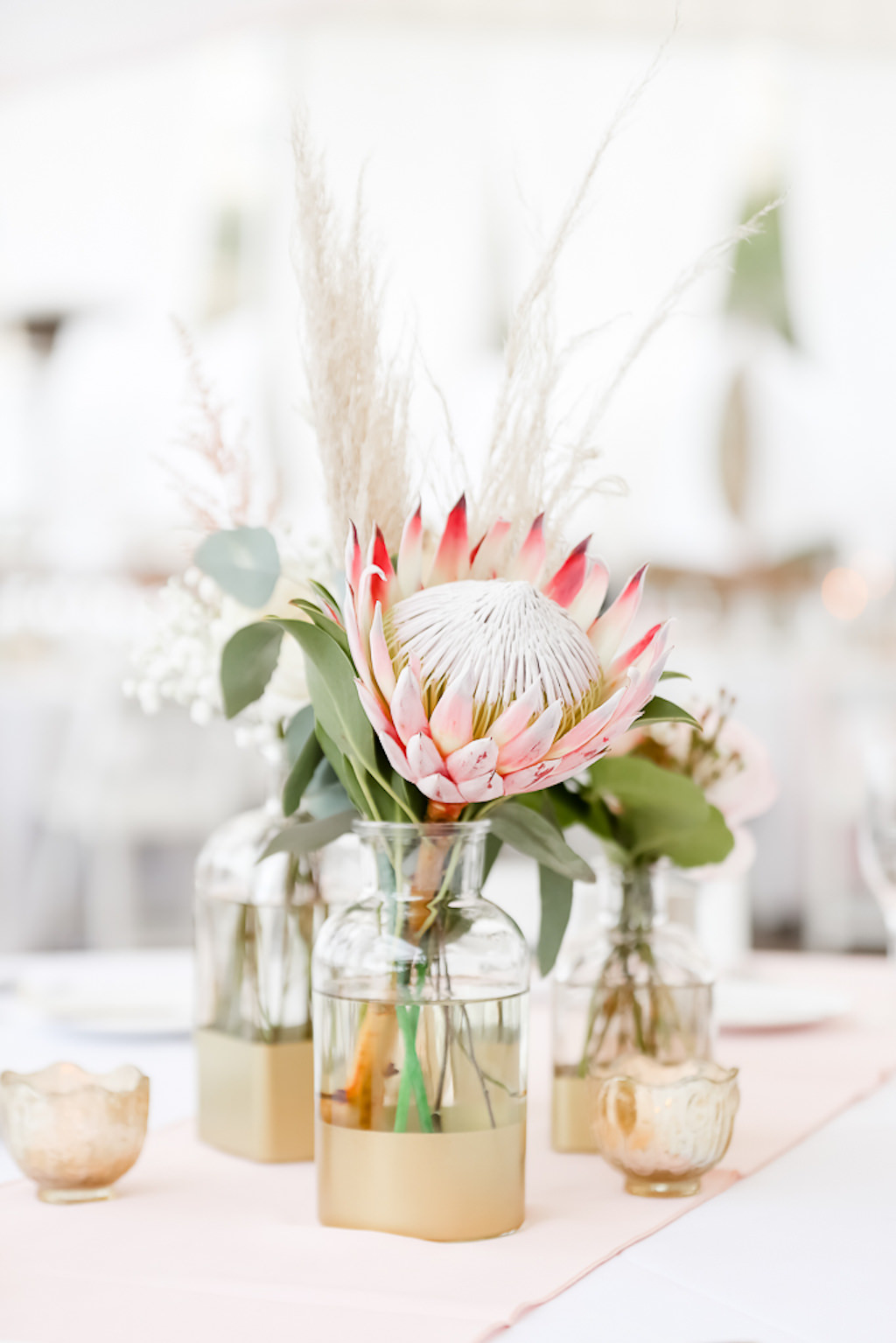 Tropical Inspired Wedding Reception Decor, Pink King Protea in Clear Glass and Gold Vase, Low Floral Centerpiece | Photographer Lifelong Photography Studios