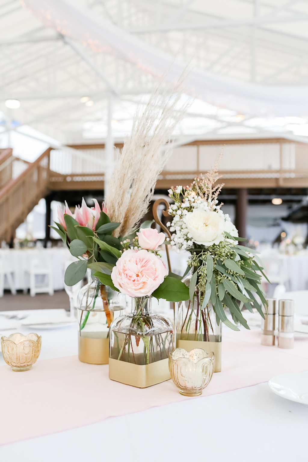 Tropical Inspired Wedding Reception Decor, Blush Pink and White Garden Roses with Greenery, Pink King Protea, in Clear Glass and Gold Vase, Low Floral Centerpiece | Photographer Lifelong Photography Studios