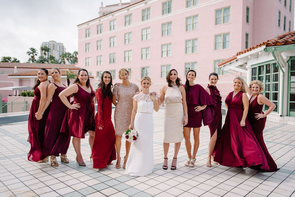 Fun Bridal Party Portrait of Bridesmaids in Mismatched Red, Magenta Dresses with Bride | St. Pete Wedding Photographer Kera Photography | St. Pete Wedding Hair and Makeup Artist Michele Renee the Studio | St. Pete Wedding Venue Vinoy Renaissance