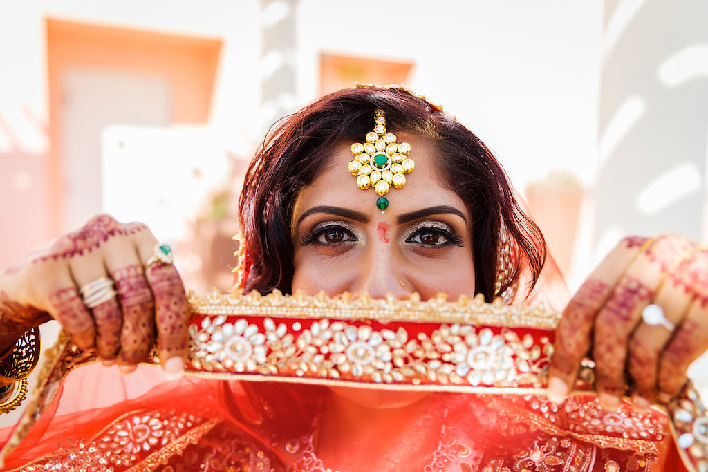 Tampa Bay iHindu Indian Bride with Red, Gold and Rhinestone and Pearl Embellished Dupatta Veil, Gold and Green Beaded Head Jewelry and Henna Tattoo Hands | Hair and Makeup Artist Destiny and Light Makeup Group