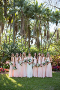 Outdoor Florida Bridal Party Portrait, Bridesmaids in Blush Pink Floor Length Bridesmaids Dresses Holding White and Greenery Floral Bouquets | Sarasota Wedding Venue Marie Selby Botanical Gardens