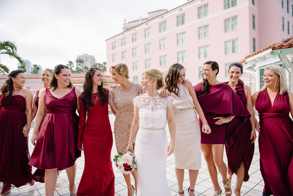 Fun Bridal Party Portrait of Bridesmaids in Mismatched Red, Magenta Dresses with Bride | St. Pete Wedding Photographer Kera Photography | St. Pete Wedding Hair and Makeup Artist Michele Renee the Studio | St. Pete Wedding Venue Vinoy Renaissance