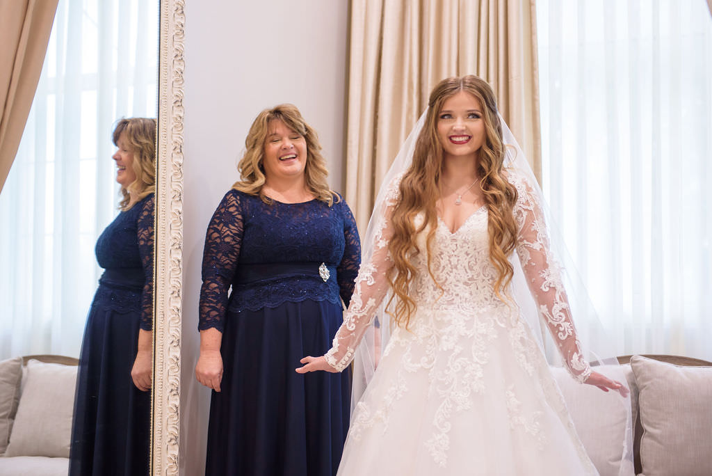 Florida Bride Getting Ready Wedding Portrait in Lace and Illusion Long Sleeve Deep V Neckline Ballgown Wedding Dress | Tampa Bay Hair and Makeup Destiny and Light Hair and Makeup Group | Wedding Dress Shop Truly Forever Bridal