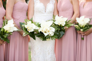 Florida Bride and Bridesmaids Outdoor Wedding Portrait, Bridesmaids in Mismatched Style Dusty Rose Dresses, Bride in Lace Fitted Sweetheart Neckline and Tank Top Strap Wedding Dress with White Cala Lily Floral Bouquets | St. Pete Photographer LifeLong Photography Studios