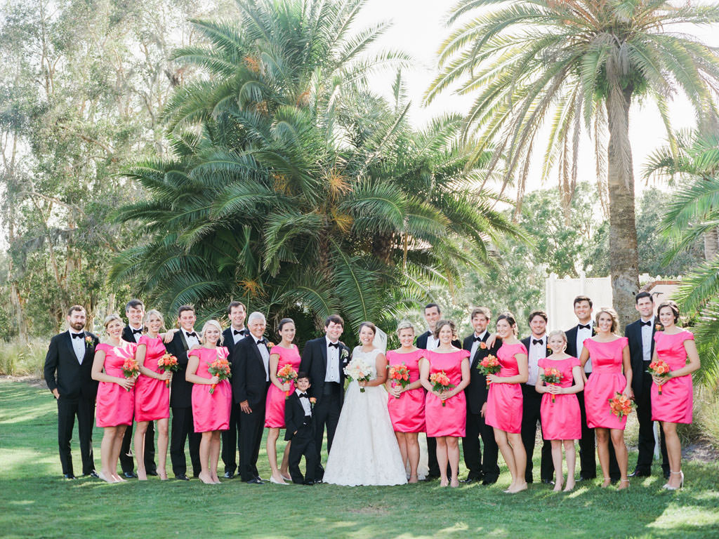 Florida Outdoor Kate Spade Inspired Wedding Party Portrait, Bridesmaids in Bright Pink Matching Short Dresses with Colorful Floral Bouquets, Groomsmen in Black Tuxedos