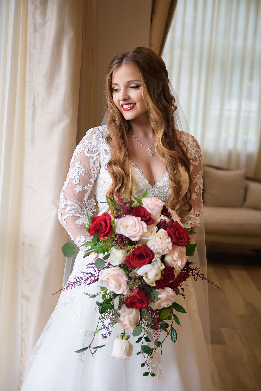 Florida Bride Wedding Portrait in Lace and Illusion Long Sleeve Deep V Neckline Ballgown Wedding Dress and Red, Blush Pink, Ivory, Greenery Floral Bouquet | Tampa Bay Hair and Makeup Destiny and Light Hair and Makeup Group | Wedding Dress Shop Truly Forever Bridal