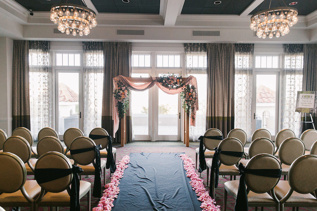 Indoor Ballroom Wedding Ceremony Decor, Wooden Arch with Blush Pink Draping, Colorful Flower Bouquets and Green Chairs | Downtown St. Pete Wedding Hotel Venue The Birchwood