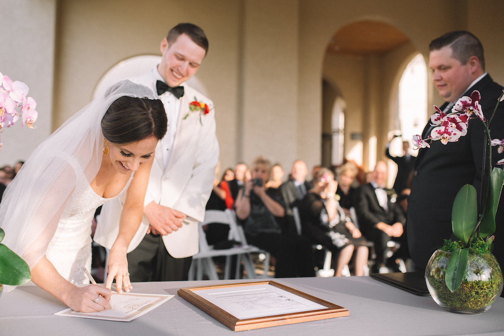 Tampa Bay Bride and Groom Sign Marriage License During Wedding Ceremony Portrait, Orchid Floral Wedding Decor | Boutique Hotel Wedding Venue Fenway Hotel