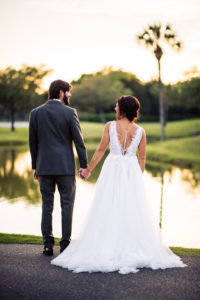 Tampa Bay Bride and Groom Holding Hands From Behind Wedding Portrait, Bride in Sleeveless Low Back Tulle Wedding Dress, South Tampa Wedding Venue Palma Ceia Golf & Country Club | Planner Breezin' Weddings