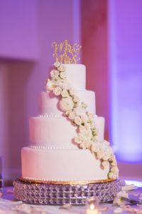 Elegant Wedding Decor and Cake Table, Four Tier Classic White Wedding Cake on Crystal Cake Stand, White Floral Arrangement, Gold Glitter Mr. and Mrs. Cake Topper | Tampa Bay Wedding Venue Innisbrook Golf & Spa Resort