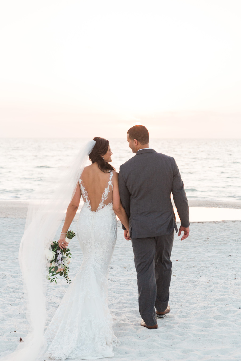 St. Pete Beach Bride and Groom Beach Sunset Wedding Portait, Bride in Open Low Back Lace and Illusion Strap Fitted Wedding Dress and Cathedral Veil