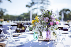 Rustic Southern Chic Garden Wedding Decor, Colorful Floral Low Wildflower Centerpiece, Baby's Breath and Mixed Floral Arrangements in MultiColored Vases, South Tampa Outdoor Wedding Venue Palma Ceia Golf & Country Club | Tampa Bay Wedding Planner Breezin' Weddings