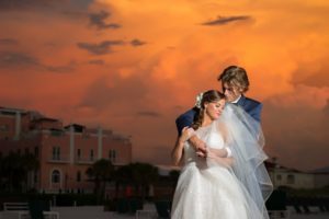 Florida Bride and Groom Wedding Portrait at Sunset on St. Pete Beach, Bride in Soft White A-line Wedding Dress With Sheer Top | St. Petersburg Beach Resort and Hotel Wedding Venue The Don Cesar | Tampa Bay Wedding Photographer Andi Diamond Photography | | Tampa Wedding Dress Shop Truly Forever Bridal