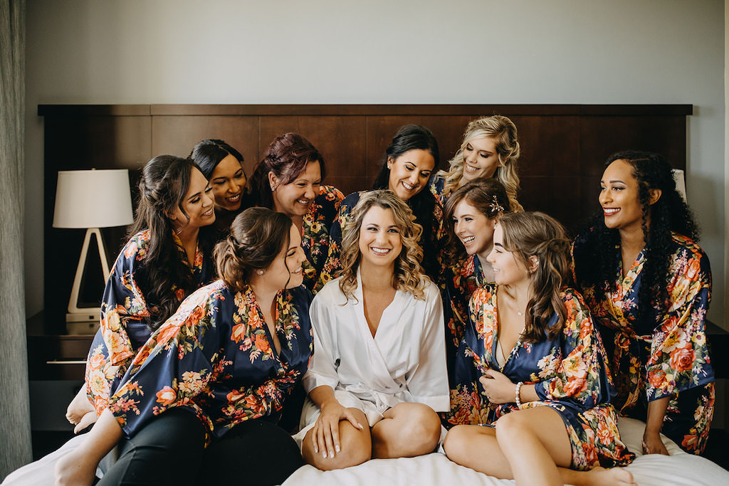 Florida Bride and Bridesmaids Getting Ready Wedding Portrait in Matching Navy, Peach and Green Floral Robes | Tampa Bay Wedding Courtyard by Marriott St. Petersburg Downtown