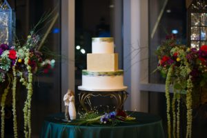 Three Tier Round Geometric Unique Shape Wedding Cake with Square Middle Tier, White and Watercolor Frosting, Gold Imprinted Design, White and Gold Cake Stand on Emerald Table Cloth with Jewel Toned Inspired Multi Color Floral Arrangements with Greenery | | Tampa Bay Wedding Photographer Andi Diamond Photography