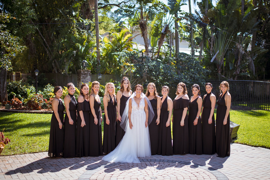 Florida Bride and Bridesmaids Outside Wedding Portrait, Bride in Sleeveless Deep Plunge Neckline Wedding Dress, Bridesmaids in Mix and Match Sleeveless Long Black Dresses | South Tampa Wedding Venue Palma Ceia Golf & Country Club