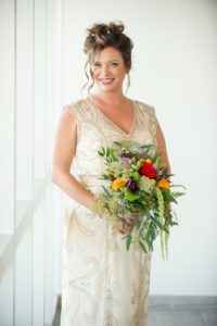 Bride in Elegant Ivory and Gold Beaded Detailing V-Neck Sleeveless Sheath Style Wedding Dress, Wearing Hair in Updo with Curls, Carrying Eclectic Colorful Mix Flower Bouquet | Tampa Bay Wedding Photographer Andi Diamond Photography| Tampa Bay Wedding Makeup Artist Michelle Renee the Studio | Tampa Bay Florist Apple Blossoms Floral Designs