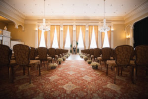 Florida Wedding Ceremony with Elegant Armless Accent Chairs, Baby's Breath Floral Arrangement in Galvanized Metal Buckets Lining Aisle of Ceremony | South Tampa Wedding Venue Palma Ceia Golf & Country Club