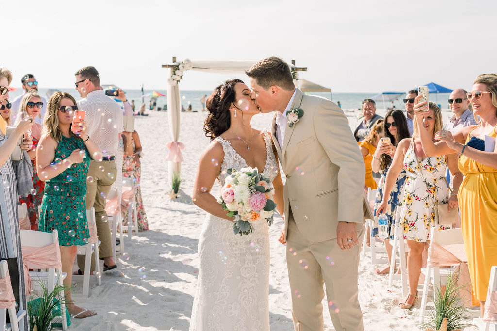 Clearwater Beach Bride and Groom Kiss During Wedding Ceremony Exit | Planner Gulf Beach Weddings