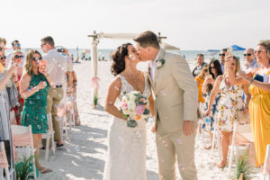 Clearwater Beach Bride and Groom Kiss During Wedding Ceremony Exit | Planner Gulf Beach Weddings