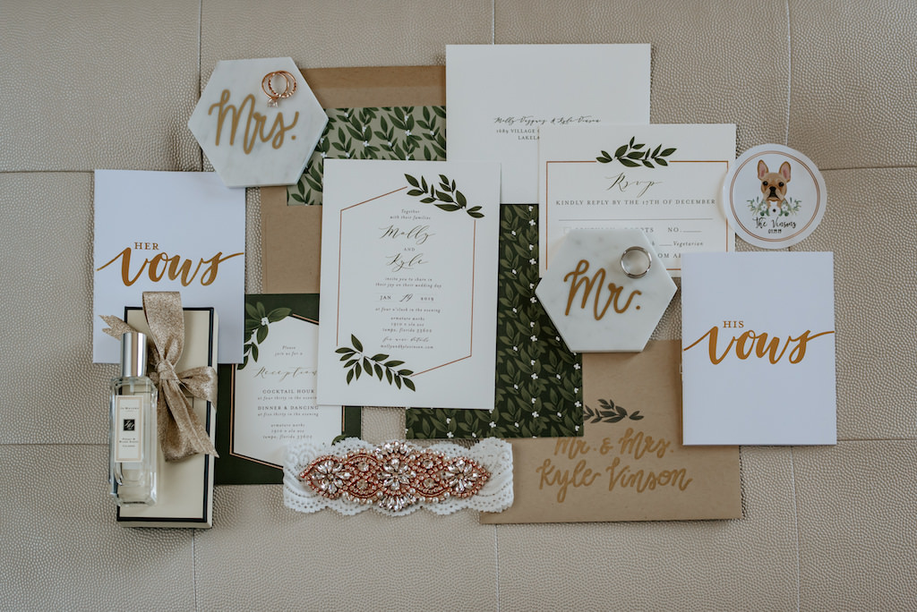 Modern Geometric Gold, Navy, Sage and Dark Green Wedding Invitation Suite Flat Lay with Lace and Gold Beaded Garter, Wedding Rings