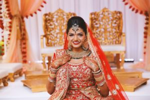 Traditional Elegant Indian Bride Beauty Wedding Portrait in Red and Gold Sari and Veil, Extravagant Jewelry and Henna Tattoo | Tampa Wedding Hair and Makeup Michele Renee the Studio