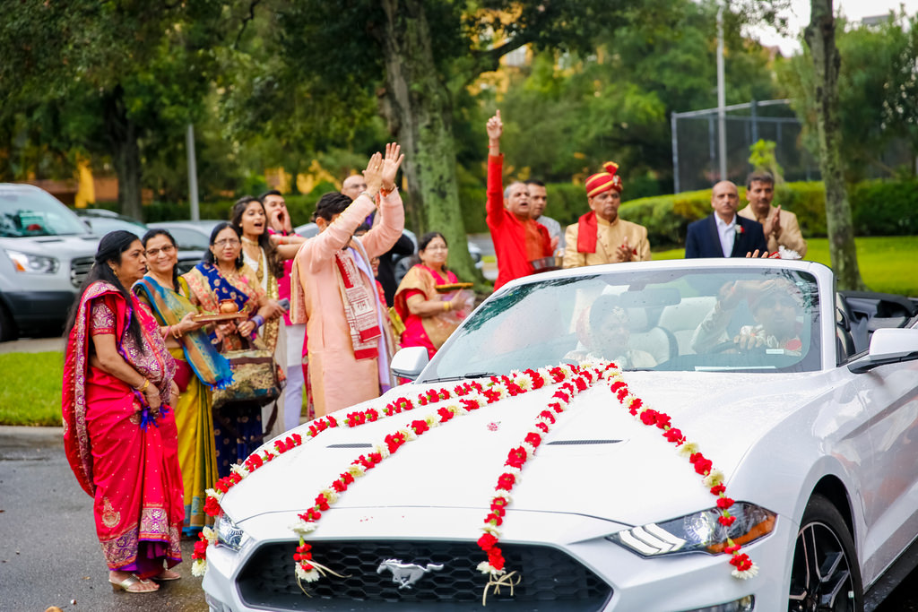 Traditional Indian Wedding Party Portrait and White Mustang Car with Red and White Floral Leis