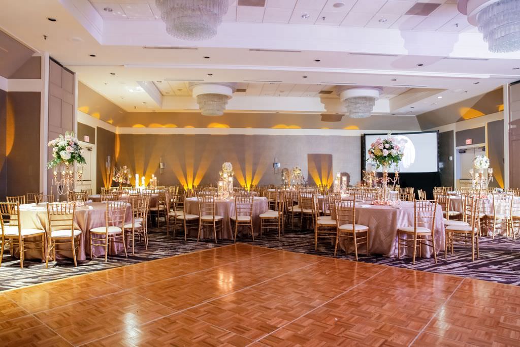 Elegant Wedding Reception Ballroom Decor, Round Tables with Blush Pink Linens, Gold Chiavari Chairs, Tall Gold Candelabras and White, Blush Pink and Greenery Floral Centerpieces | Tampa Wedding Venue Hilton Tampa Airport Westshore
