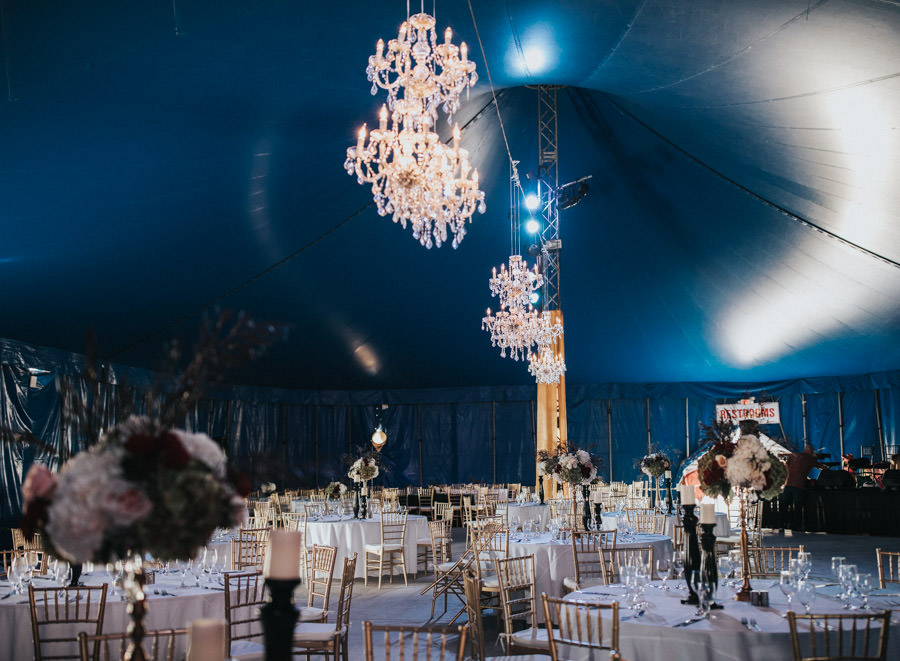 Glamorous, Circus Inspired Wedding Reception, Under The Big Top, Suspended Chandelier Lighting, Gold Chiavari Chairs, Gold Drapping, Tall Floral Centerpieces, Circus Sarasota | Circus Sarasota under the Big Top at UTC