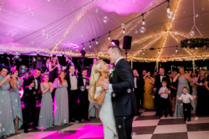 Florida Bride and Groom First Dance Tent Wedding Reception with String Lights and Pink Uplighting Portrait