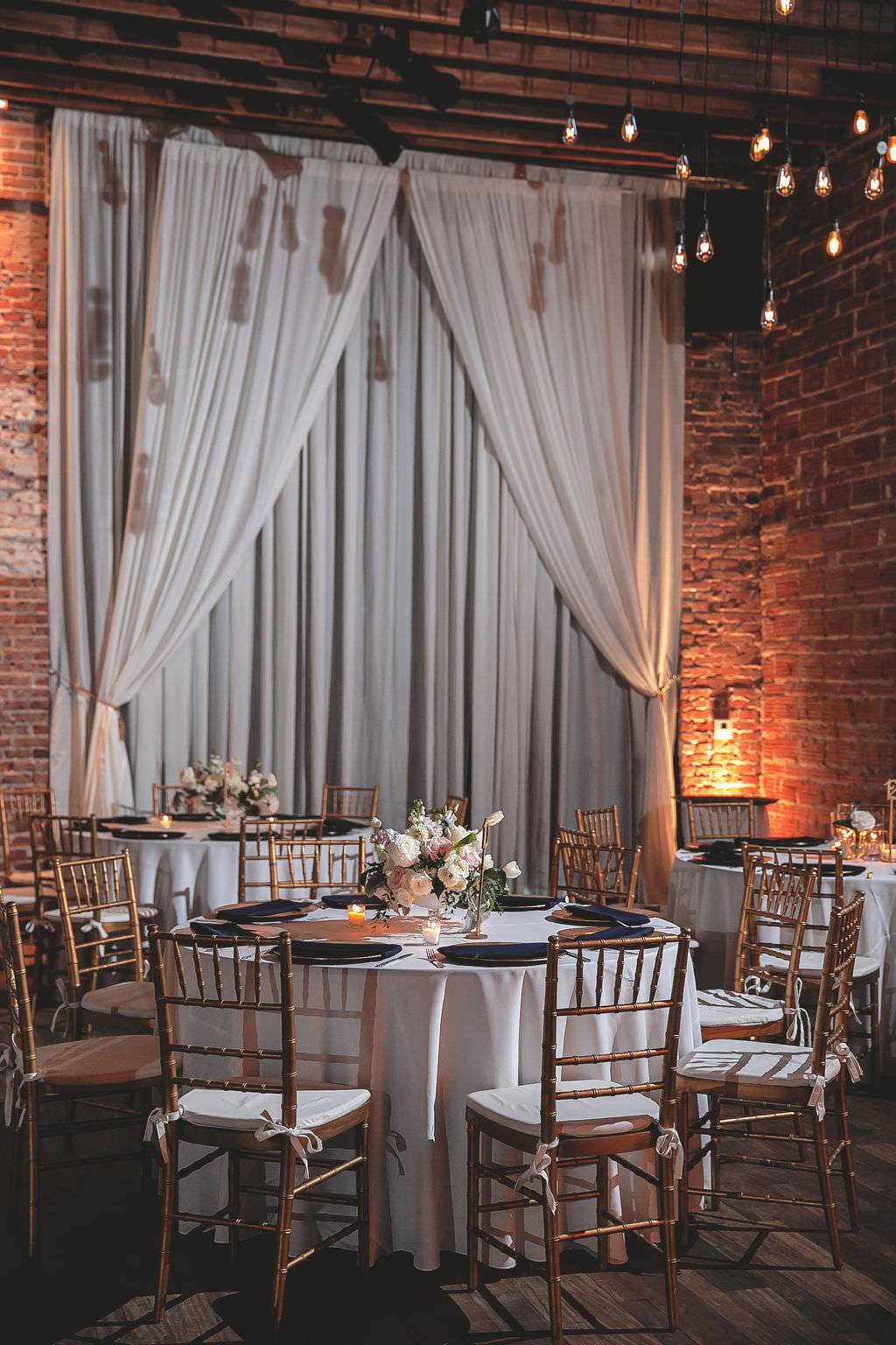Classic Indoor Reception with Wedding Decor, Gold Chiavari Chairs, Round Tables with White Lines, Low Floral Centerpieces, Ivory, Blush Pink, Florals with Greenery | Historic Tampa Bay Wedding Venue NOVA 535