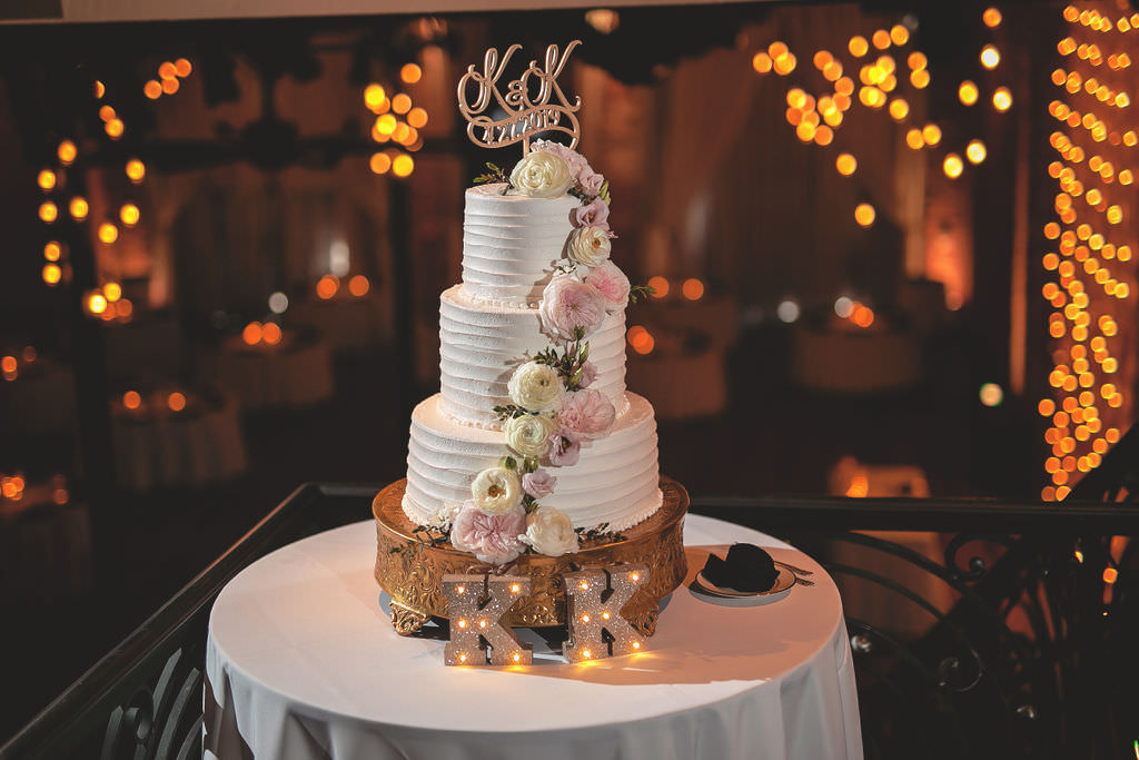 Elegant There Tier White Buttercream Wedding Cake with Cascading Peony Flowers, Blush Pink and Ivory Flowers, Gold Personalized Wedding Topper, Large Gold Cake Stand | Tampa Bay Wedding Caterer and Cake Baker Olympia Catering