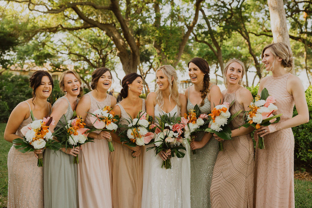 Sarasota Bride and Bridesmaids Wedding Portrait, Bride in Spaghetti Strap White Beaded Karen Willis Holmes Wedding Dress, Bridesmaids in Beige Sage and Blush Mix and Match Beaded Adrianna Papell Dresses, Carrying Tropical Wedding Bouquet with Colorful Flowers, Pink Ginger, Orchids, with Greenery