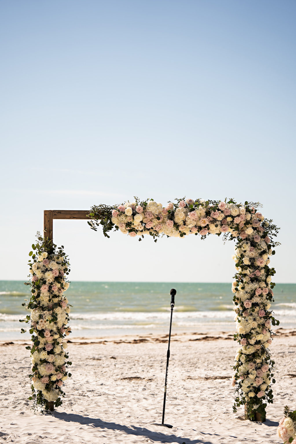 Romantic Garden Inspired Floral Square Wedding Arch at Oceanfront Ceremony on White Sand, White and Blush Pink Florals with Greenery | Tampa Bay Florist Bruce Wayne Florals | Florida Planner Parties A La Carte | St. Pete Beach Wedding Venue The Historic Don Cesar Hotel