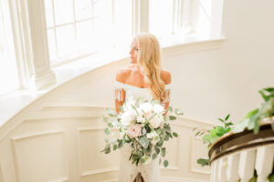 Tampa Bay Bride Wedding Portrait on Staircase Holding Organic Garden White Ivory Blush Pink Floral and Greenery Bouquet | South Tampa Wedding Hair and Makeup Artist LDM Beauty Group