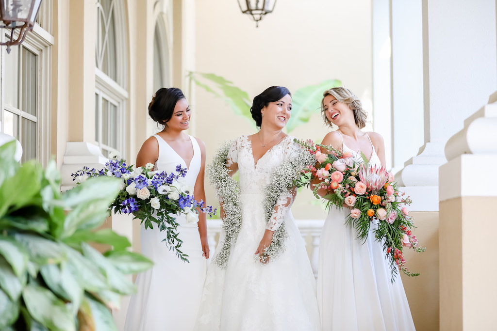 Brides Carrying Unique Floral Wedding Bouquets, Purple Hibiscus, Ivory Carnations, Baby's Breath Garland, Tropical Inspired, Garden Crescent Style Wedding Bouquet with Pink King Protea, Peach, White and Orange Florals with Greenery | Tampa Bay Wedding Photographer Lifelong Photography Studios | Truly Forever Bridal Shop Sarasota