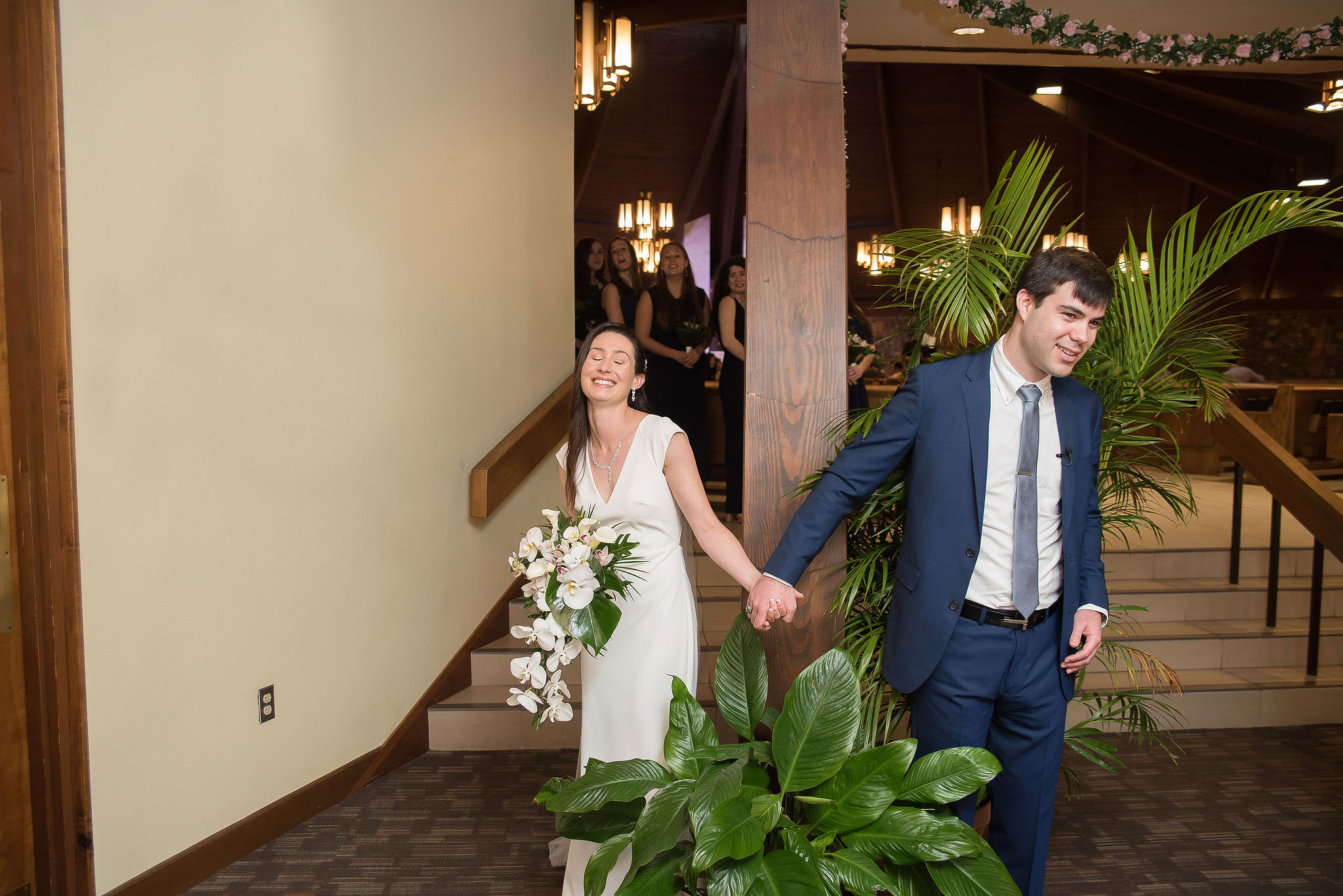 Florida Bride and Groom Holding Hands Before First Look in Hotel Lobby with Orchid Floral Bouquet | Tampa Bay Kristen Marie Photography