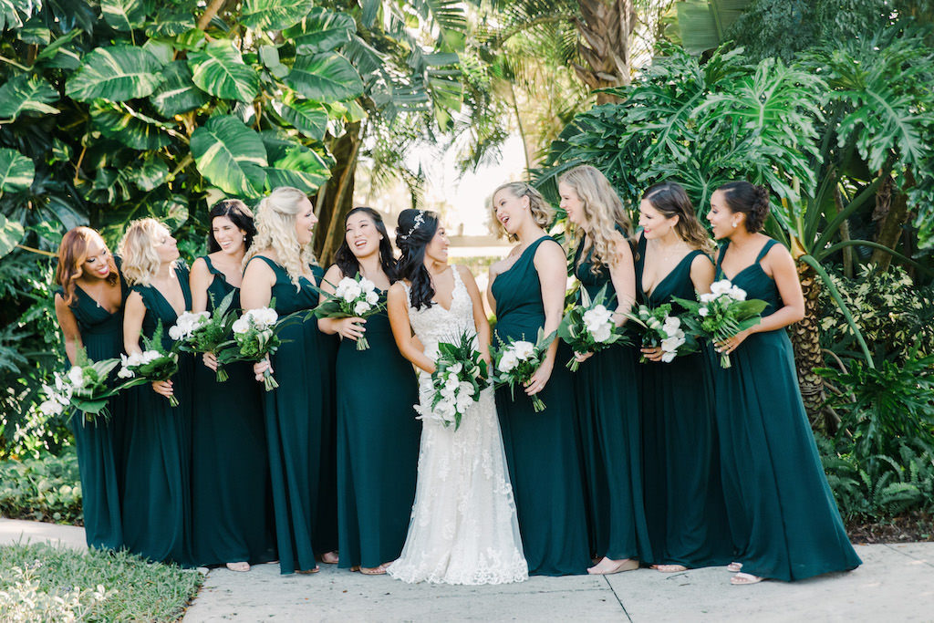 St. Pete Bridal Party Bridesmaids in Modern Long Dark Green Monique Lhuillier Bridesmaid Dresses from Bella Bridesmaids, Carrying White Orchid and Green Palm Leaf Bouquet, Boho Bride in Martina Liana Wedding Dress with Straps and V Neckline | Tampa Bay Florist Bruce Wayne Florals | Waterfront Hotel Wedding Venue The Vinoy Renaissance | Hair and Makeup Artist Michele Renee The Studio