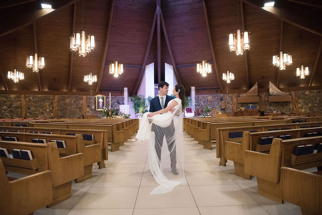 Groom Carrying Bride Wedding Portrait | Tampa Bay Kristen Marie Photography | Traditional Wedding Venue Tarpon Springs St Ignatius of Antioch Catholic Church