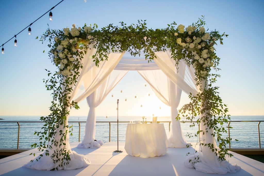 White Draped Jewish Wedding Ceremony Chuppah with Greenery and White Flowers | Clearwater Beach Waterfront Wedding Venue Opal Sands
