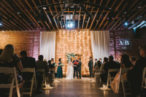 Florida Bride and Groom Exchanging Vows, Modern, Industrial Indoor Wedding Ceremony, String Light and Red Brick Backdrop| Downtown St. Pete Venue NOVA 535 | Tampa Bay Photographer Kera Photography