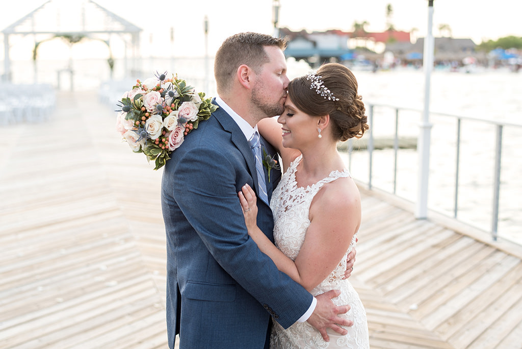 Florida Bride and Groom Wedding Portrait at Sunset Waterfront Dockside Wedding Ceremony, Carrying White, Ivory, Blush Pink Roses, Thistle, Floral Wedding Bouquet with Greenery | Tampa Bay Hotel and Wedding Venue The Godfrey Hotel & Cabanas