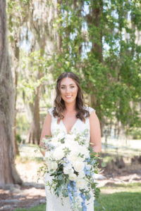 Palm Harbor Bride Outdoor Wedding Portrait in Mikaella Lace Wedding Dress with Capsleeves, Plunging V Neckline Holding White, Ivory, Blue and Greenery Organic Floral Bouquet | Tampa Bay Wedding Photographer Kristen Marie Photography | Destiny and Light Hair and Makeup Group