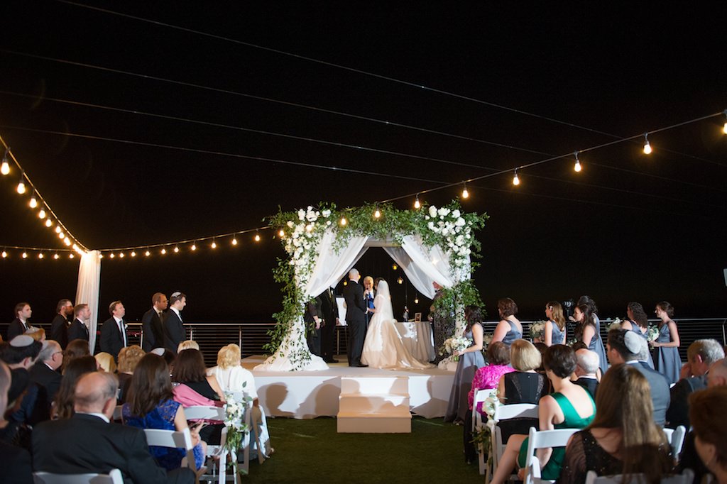 White Draped Jewish Wedding Ceremony Chuppah with Greenery and White Flowers | Clearwater Beach Waterfront Wedding Venue Opal Sands