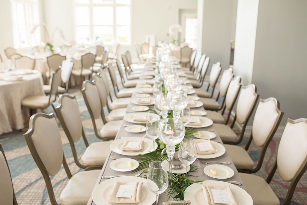 Simple, Classic Wedding Reception Decor, Long Feasting Table with Ivory Linens, Ivory Chairs, Tropical Leaves Garland and Glass Candle Centerpiece | Tampa Bay Kristen Marie Photography | Planner Special Moments Event Planning