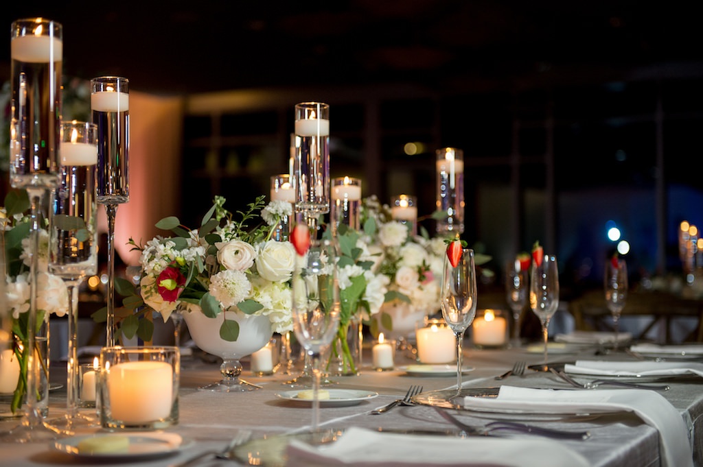Elegant, Romantic Ballroom Wedding Reception with Long Feasting Tables, Low White Centerpieces, and Candles
