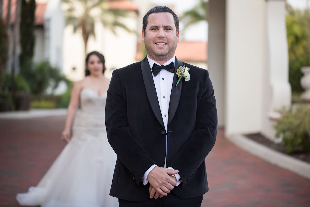 Tampa Bay Groom in Black Tuxedo and Bowtie with White Rose Floral Boutonniere Waiting for Bride First Look Wedding Portrait