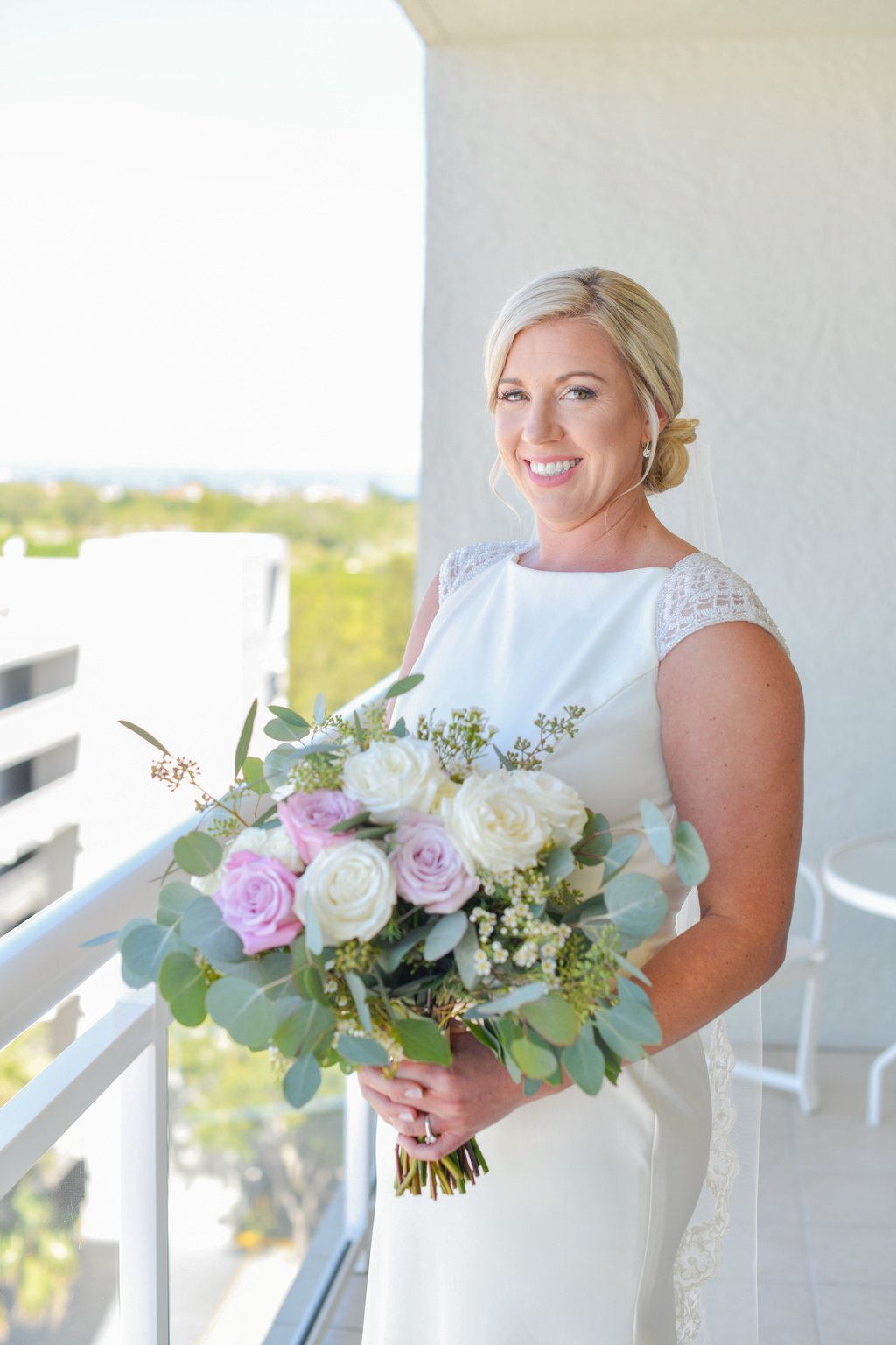 Florida Bride in Fitted White Cap Sleeve High Neckline Christina Wu Wedding Dress Holding Garden Organic White, Ivory, Purple Roses, Silver Dollar Eucalyptus and Greenery Floral Bouquet Wedding Portrait